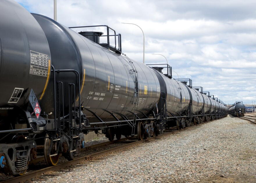 A train hauls tanker cars full of oil.