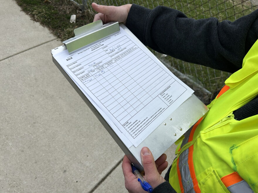 Close up view of man holding clipboard with a form on it.