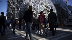 Pedestrians cross the street at Amazon headquarters in Seattle in September. 