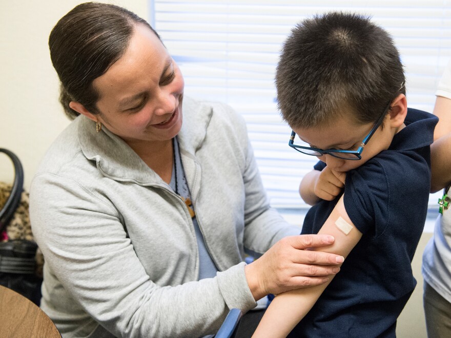 Luz Barajas took her son Carlos Cholico to get his flu shot at Crawford Kids Clinic in Aurora, Colo., last year. Health officials say there is some evidence the flu shot is more protective than the nasal flu vaccine.