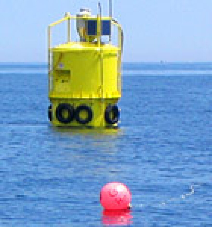 This feed buoy, laden with electronics, floats over cages submerged in water that's 180 feet deep.