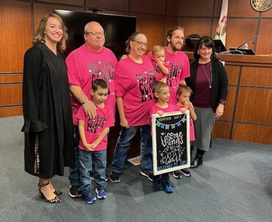 Lisa and Scott Skeate pose with their family following the adoption proceedings in Williamson County.