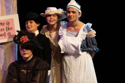 New England Youth Theatre: The Family Vacation troupe performing on stage with masks
