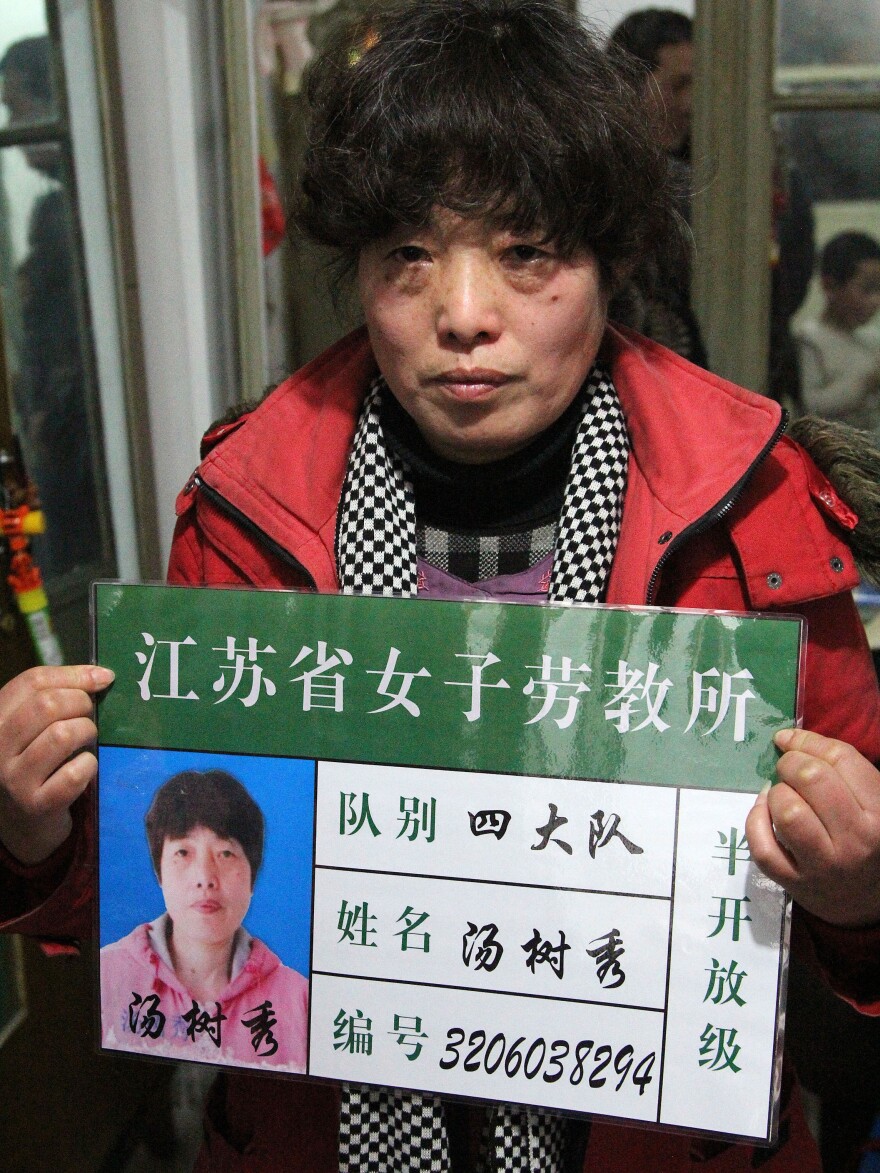 Tang Shuxiu, 51, was sent to a re-education through labor camp in 2011 after she complained that her local government work unit failed to give her an apartment. She holds a mock-up of her labor camp ID card in order to publicize the abuses of labor camps and push for change.