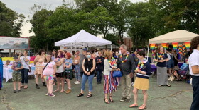A group of people gather around vendor tents at Portsmouth Pride in 2021.