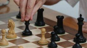 Grandmaster chess player Garry Kasparov makes a move in a match against grandmaster Fabiano Caruana during the final day of the Grand Chess Tour at the Chess Club and Scholastic Center in St. Louis.