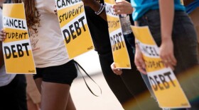 Activists hold cancel student debt signs as they gather to rally in front of the White House in Washington, DC, on Aug. 25, 2022. (Stefani Reynolds/AFP via Getty Images)