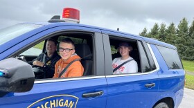 Teens and a trooper in an MSP patrol car