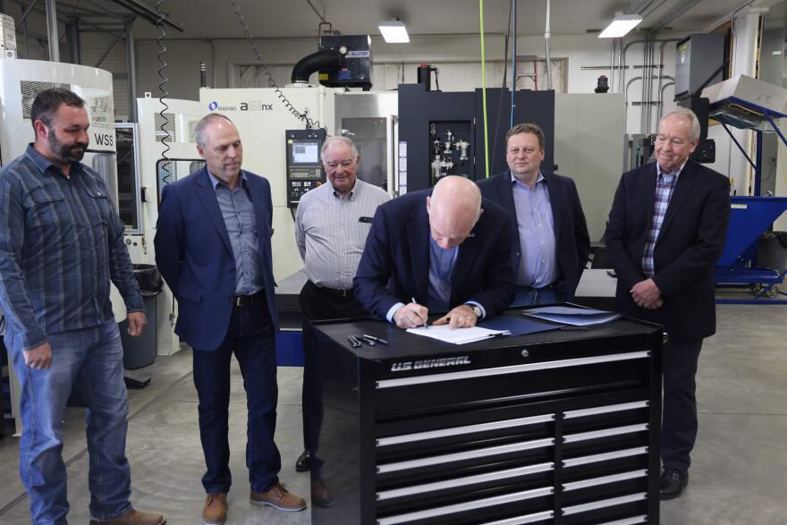 Gov. Gianforte signs Senate Bills 159 and 399 into law May 6, 2021 besides (L to R) Steven Thompson, Sen. Greg Hertz (R-Polson), Ray Thompson, Senate President Mark Blasdel (R-Kalispell), and Director of Commerce Scott Ostermann.