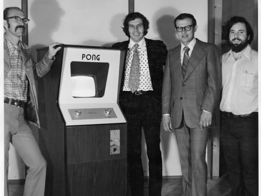 Ted Dabney (far left) stands in front of a Pong arcade machine in 1973 with (left to right) co-founder Nolan Bushnell, head of finance Fred Marincic and the man credited with the idea for Pong, Allan Alcorn.
