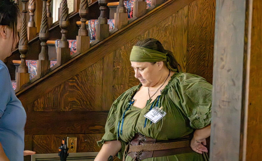 Volunteer helping someone attending the Hobbit day celebration. Photo by Alexander Brown.