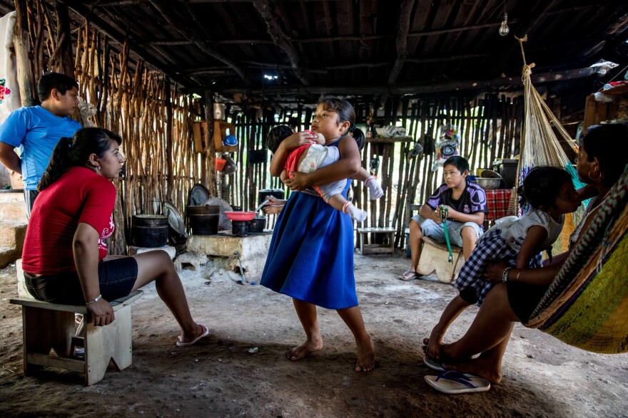In many Mexican communities, children have the chance to contribute to their families by helping take care of toddlers and babies. Here, Ruby holds her cousin Daphne in her grandmother's home.