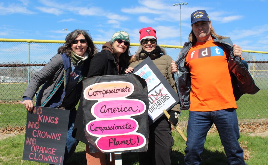 (left to right) Yasmina Kulauzovic, Julie Gibson, Hiba Taylor and Mike Dalrymple hold signs at the "No Kings" protest in Peoria.