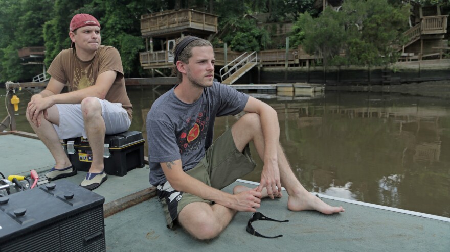 Louis Marcell and Adam Jones prepare to search for old logs, known as sinker wood, on the bottom of Ashley River near Charleston, S.C. They use sonar and a book of old train lines to find the timber, some of which has been preserved in the mud since the 1800s.