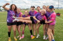  Members of an Ultimate team celebrate on a playing field.