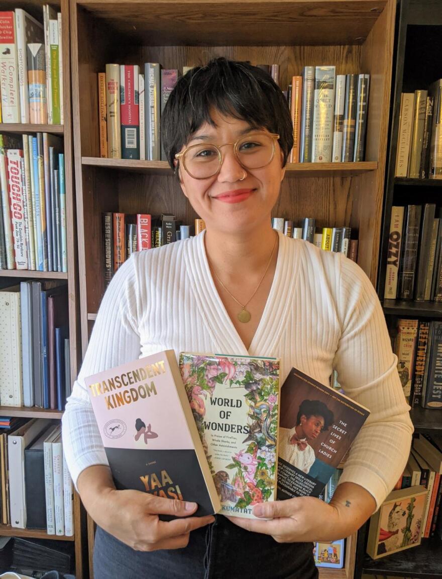 Michelle Malonzo with "The Secret Lives of Church Ladies," by Deesha Philyaw, "Transcendent Kingdom," by Yaa Gyasi and "World of Wonders," by Aimee Nezhukumatathil.