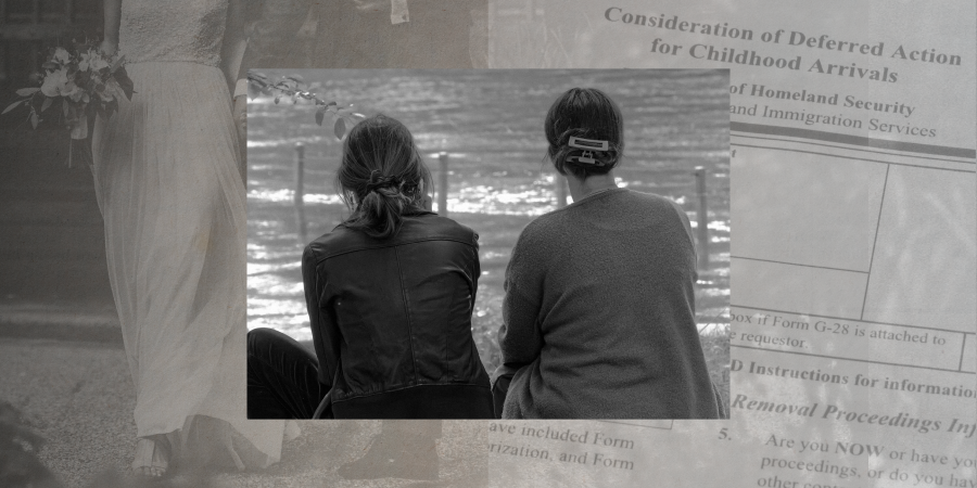 two women sitting next to each other outside