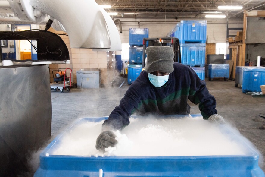 An employee makes dry ice pellets at Capitol Carbonic, a dry ice factory in Baltimore in Nov. 2020. Dry ice helps keep COVID-19 vaccines cool during transport.