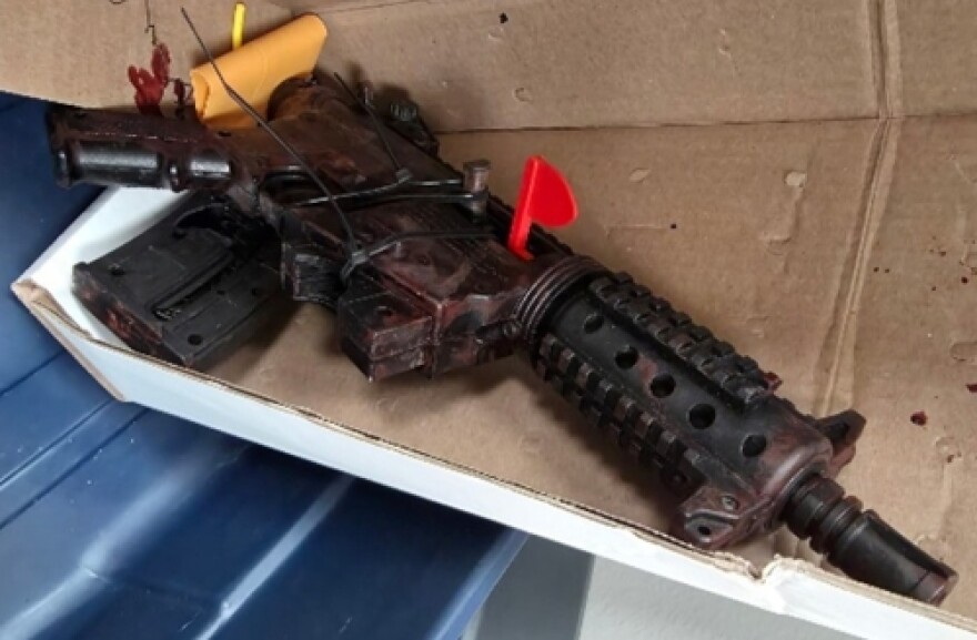 A rifle lying in an open box.