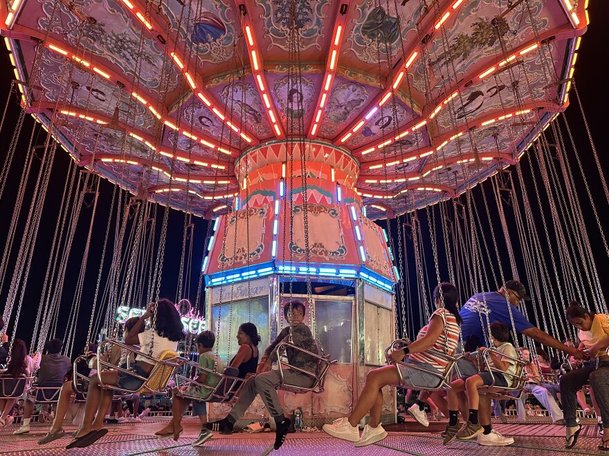 Wave Swinger riders strap in and prepare to be whirled high in the air.