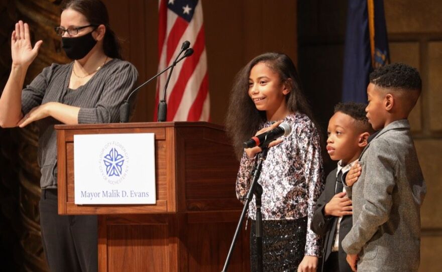 Malik Evans' kids help with the Pledge of Allegiance at his inauguration at the Eastman Theatre on Jan. 1, 2022