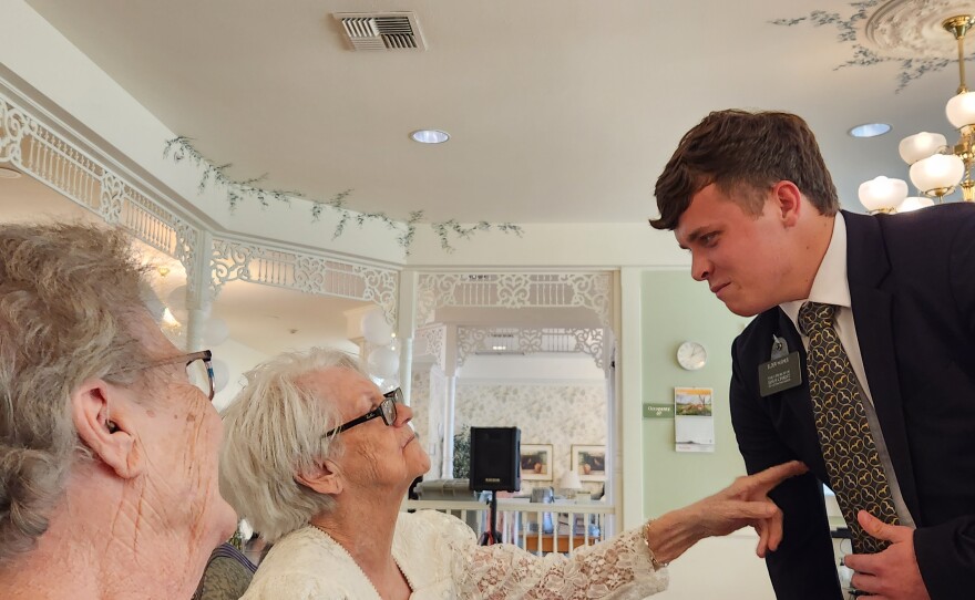Loretta (left) and Naomi (right) have fun with a young man from the Church of Jesus Christ of Latter Day Saints