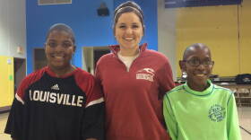 Mario (L) stands with UIndy Mentor Gabby Ingram (C) and younger brother Michel (R) following a quick pickup game of basketball.