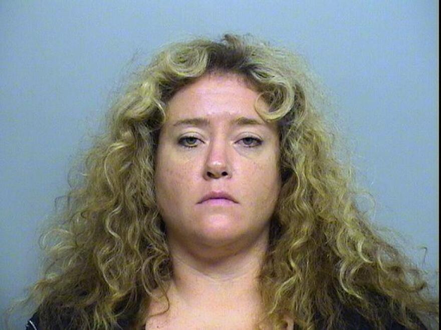 Tausha Borland shown here being booked into the Tulsa jail