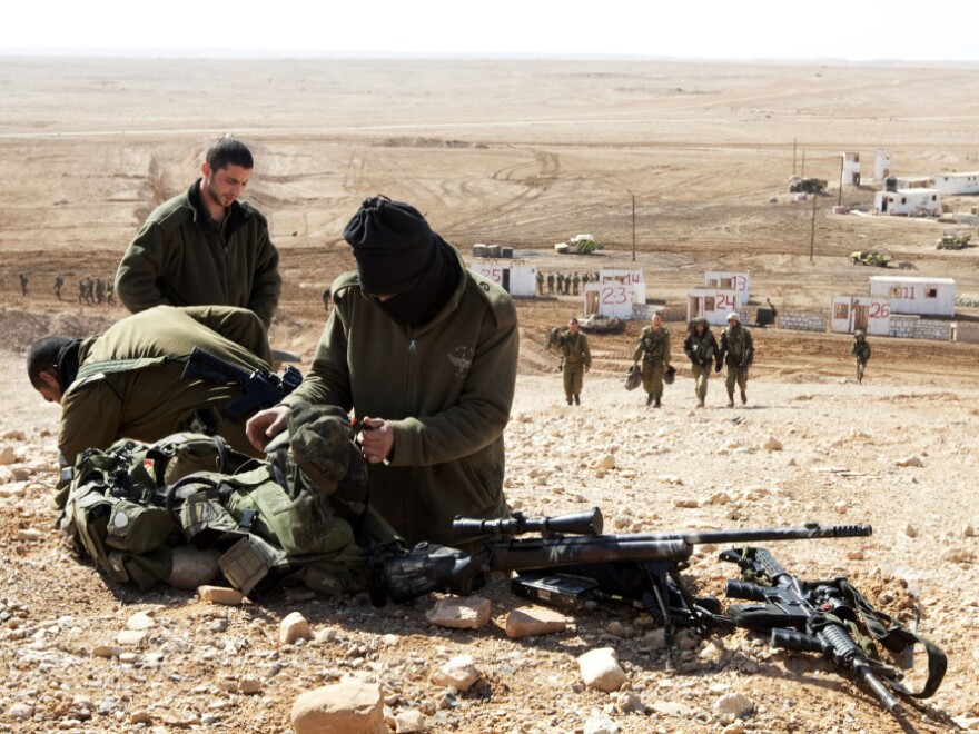 Israeli army snipers pack their gear after an army exercise at the Shizafon army base, in the Negev Desert north of the southern city of Eilat, on Tuesday.