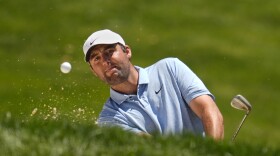 Scottie Scheffler hits from a bunker onto the fourth green during the final round of the Memorial golf tournament, Sunday, June 9, 2024, in Dublin, Ohio. 