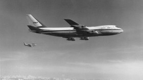 A Boeing model 747, the largest commercial jetliner in the world, flies over the Puget Sound area of western Washington state in October 1969. The 747 jet is accompanied by a Sabre V chase plane, background, to observe certain flight tests. (AP Photo)
