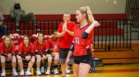 Head Coach Eric Marshall watches from the bench as Senior Rylie Tam gets ready to return a serve. (Trey Johnson/WUFT News)