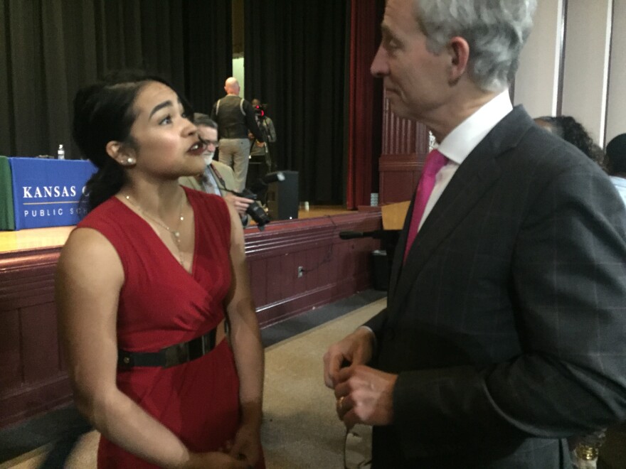 High school student Denisse Martinez speaks with attorney and mayoral candidate Steve Miller after a forum Wednesday evening at East High School. 