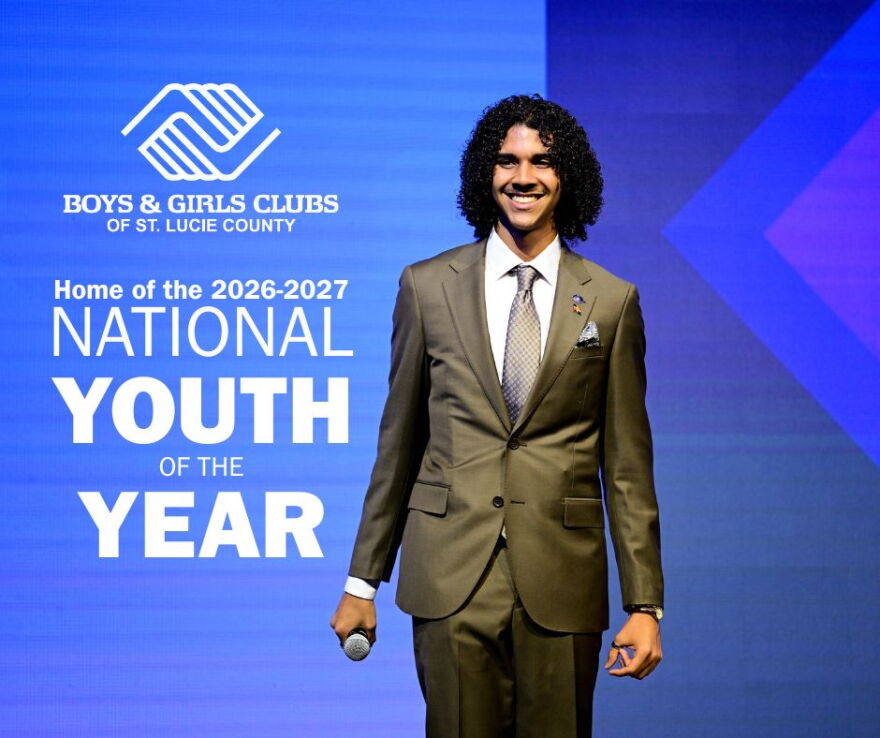 Young man in an olive suit holding a microphone on stage, beside text: “Boys & Girls Clubs of St. Lucie County, Home of the 2026-2027 National Youth of the Year.”