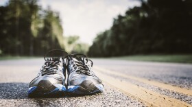 Lone pair of new running shoes, just waiting to be used on an open road.