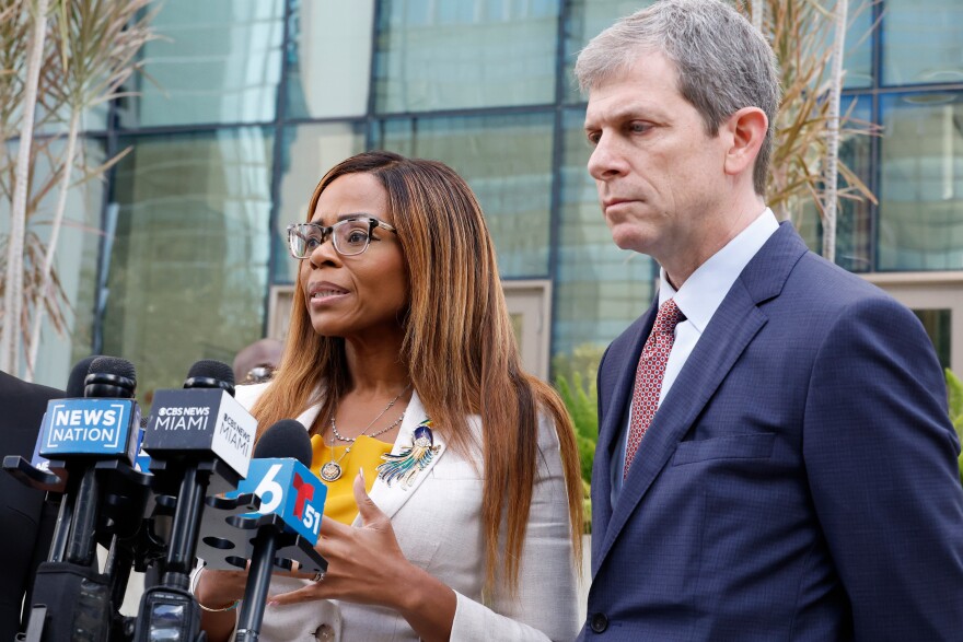 U.S. Rep. Sheila Cherfilus-McCormick, D-Fla., left, speaks to the media as her lawyer David Markus looks on after a hearing in federal court Monday, Dec. 29, 2025 in Miami. (AP Photo/Terry Renna)
