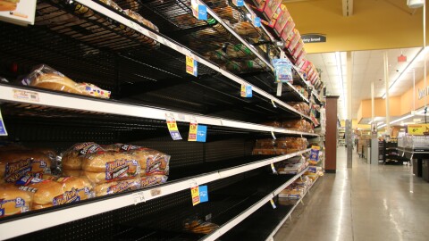 A bread aisle at Gerbes grocery store is picked through with only a few selections remaining on the shelf. 