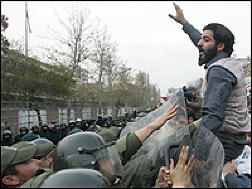 Iranian riot police prevent hardline students from approaching the British embassy in Tehran during a protest Sunday. The students are demanding the trial of 15 British sailors and marines.