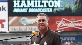 Tom Hamilton speaks at a podium at Progressive Field in Cleveland.