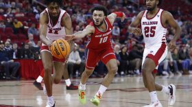New Mexico's Jaelen House and Fresno State's Isaih Moore, left, reach for the ball as Fresno State's Anthony Holland watches during the second half of an NCAA college basketball game in Fresno, Calif., Tuesday, Jan. 3, 2023. (AP Photo/Gary Kazanjian)