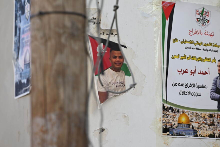 Posters hang on building walls in Ramallah in the West Bank, Oct. 31, 2023.