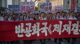 People wave banners and shout slogans as they attend a rally in support of North Korea's stance against the U.S., in Pyongyang on Aug. 9, 2017. (Kim Won-Jin/AFP/Getty Images)