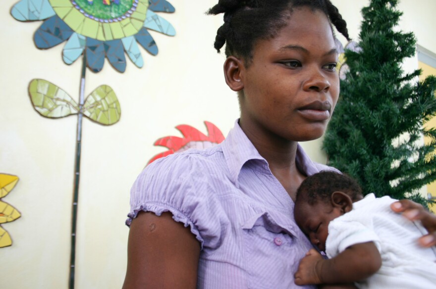 Maudeline Orelien, 22, with her son, Wilguens Pierre, who was born in July with microcephaly.