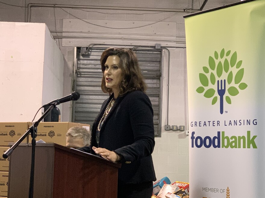 governor gretchen whitmer standing at a podium