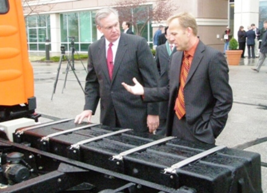 Missouri Governor Jay Nixon ( L) and SEV CEO Bryan Hansel examine truck battery