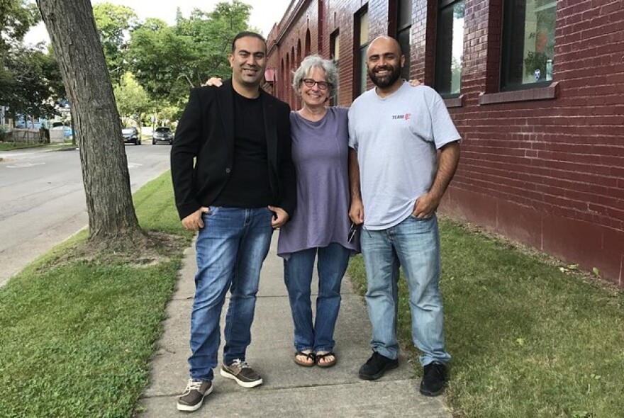 Walid Omid Habibi, Ellen Smith, and Noor Sediqi stand outside of Keeping Our Promise on St. Paul Street on July 30, weeks before the Taliban seized control of Afghanistan.