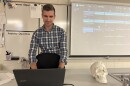 A man types on a laptop.