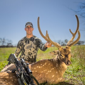 Brian Flaherty with an axis buck taken down with a Tenpoint crossbow at Choctaw Hunting Lodge in southeast Oklahoma.