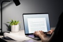 Man writing text document, essay or letter with laptop. Freelance writer, journalist or entrepreneur working late at night, overtime. Job seeker, cv resume and application. Dark home or office room.