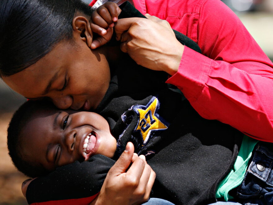 Katrena Wingo, who spent most of her life in foster care, kisses her son.